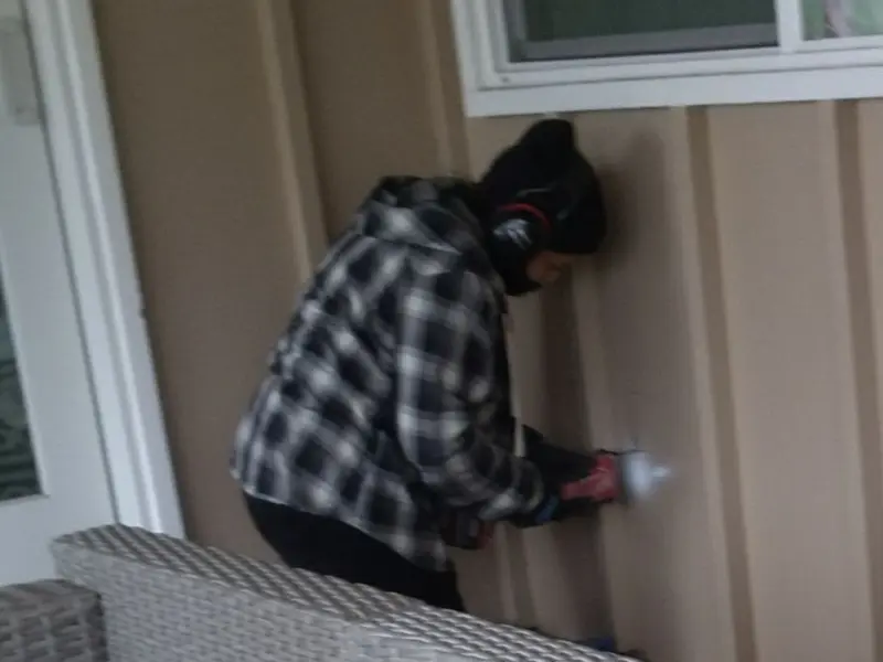 Professional electrician installing an exterior outlet in Lovejoy