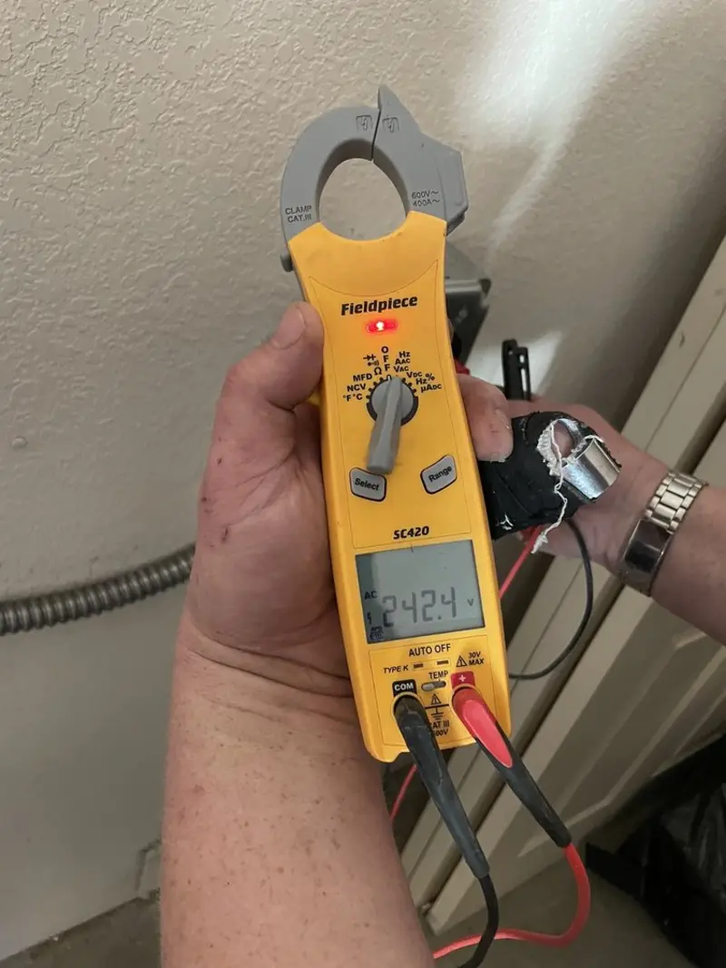 Voltage testing with clamp meter during Whole House Surge Protector in Lovejoy